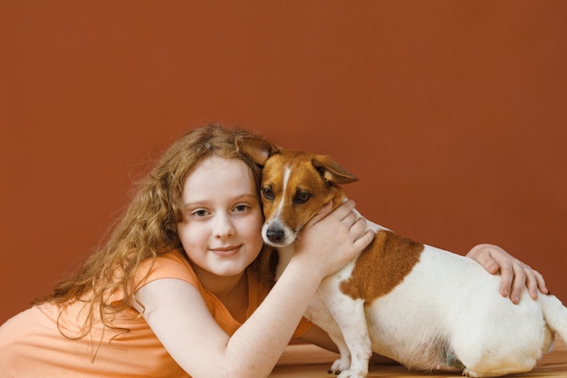 Kędzierzawa dziewczyna obejmuje jej przyjaciela psa.