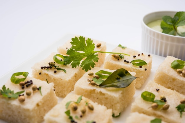 Khaman white Dhokla składająca się z ryżu lub urad dal to popularny przepis na śniadanie lub przekąski z Gujarat w Indiach, podawany z zielonym chutney i gorącą herbatą. Selektywne skupienie