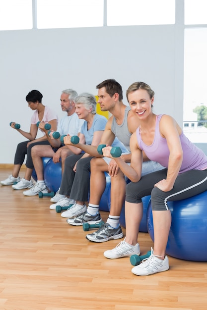 Klasa Z Hantlami Siedzi Na ćwiczenie Piłkach W Gym