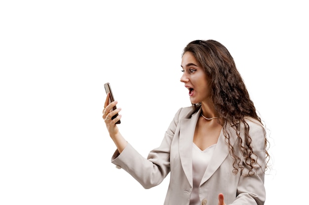 Kobieta buźka patrząc na smartfona z niespodzianką