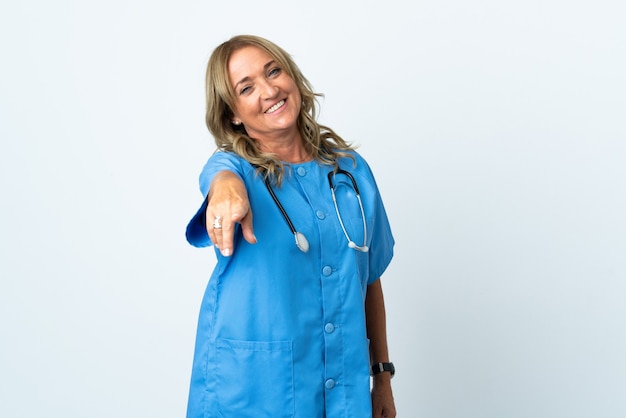 Kobieta Chirurg W średnim Wieku Na Białym Tle, Wskazując Przód Ze Szczęśliwym Wyrazem Twarzy