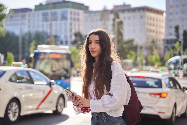 Kobieta czeka na udział w przejażdżce, gdy taksówki przejeżdżają przez Hiszpanię?