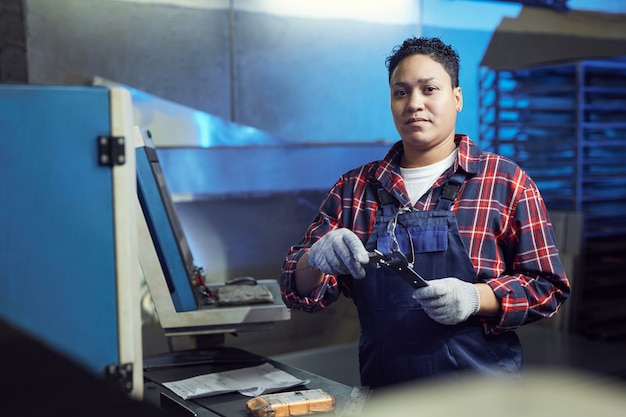 Zdjęcie kobieta pracownik naprawy maszyn w warsztacie fabrycznym