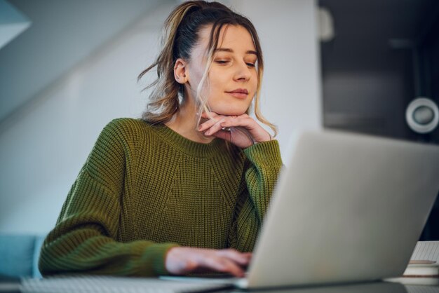 Kobieta pracująca w domu na laptopie