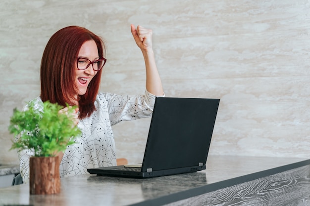 Kobieta przy biurowym biurkiem z laptopem czuje świetnie na kariery horyzoncie