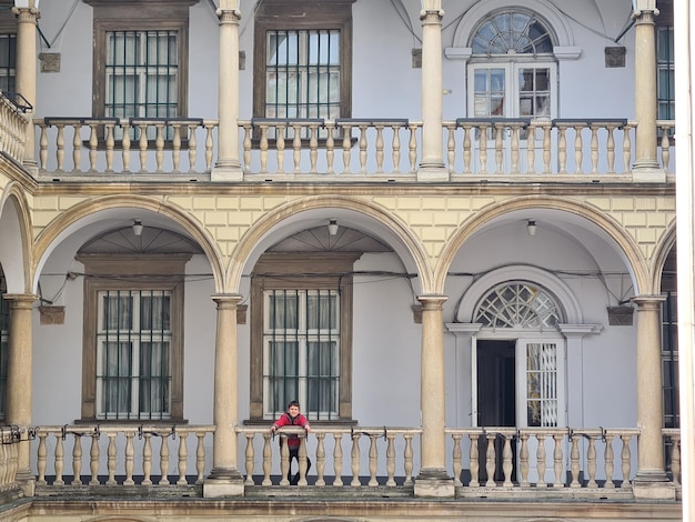 Kobieta stoi na balkonie z balkonem i napisem „słowo” z przodu. "