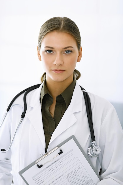 Kobieta stojąca i patrząca w kamerę Doskonała opieka medyczna w klinice Medycyna i opieka zdrowotna