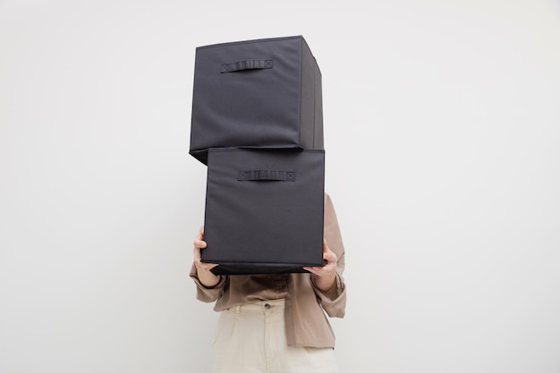 Kobieta trzymająca pudełka do organizacji szafy lub przeprowadzki Bez twarzy