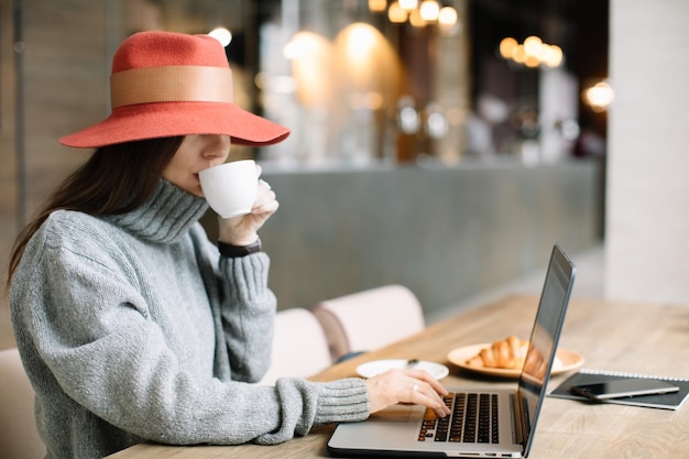 Kobieta używająca laptopa przy stole