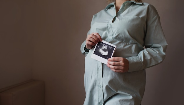 Kobieta w ciąży posiada zdjęcie USG. czekając na narodziny dziecka