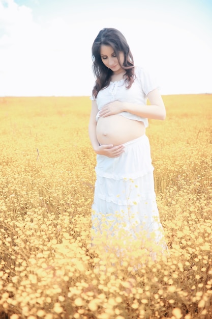 Kobieta w ciąży w przyrodzie na spacer jesienią