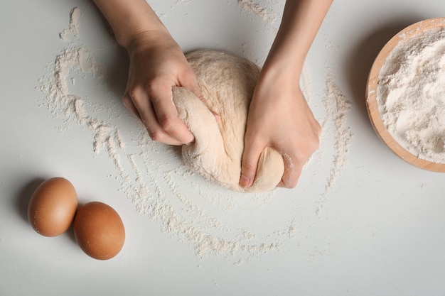 Kobieta wyrabiania ciasta na kuchennym stole