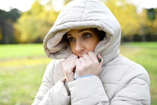 Zdjęcie kobieta z otwartymi ramionami oddycha świeżym czystym powietrzem w buszu lub na polu jesienią lub zimą