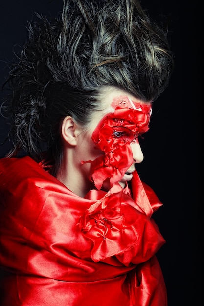 Kobieta z twórczą czerwoną twarzą sztuką