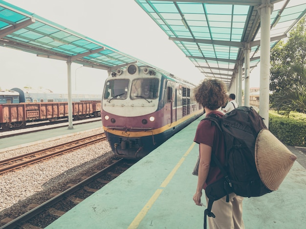 Kobiety backpacker czekania pociąg na platformie przy stacją w Wietnam. Jedna osoba podróżująca pociągiem na wakacje. Przygoda Wanderlust na całym świecie.