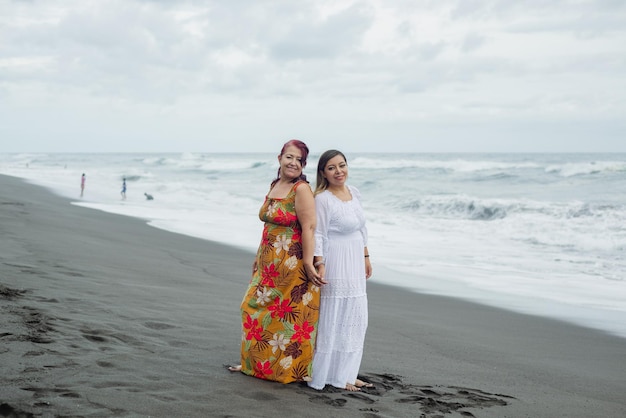Kobiety, matka i córka spędzają czas na plaży. Ocean Spokojny, pochmurny dzień.