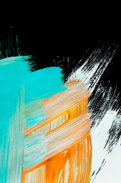Kolorowe abstrakcyjne pociągnięcia farbą akrylową na czarnym tle