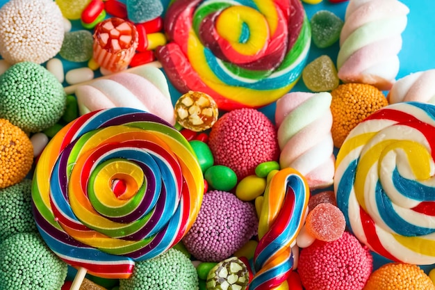 Kolorowe lizaki i różne kolorowe okrągłe cukierki. Widok z góry.