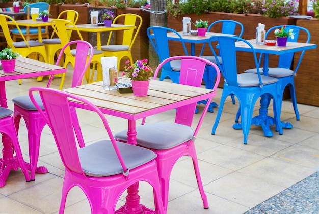 Kolorowe stoły i krzesła w kawiarni na świeżym powietrzu