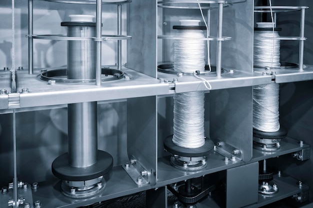 Kołowrotki nici przędzy tekstylnej w przemysłowej maszynie tkackiej