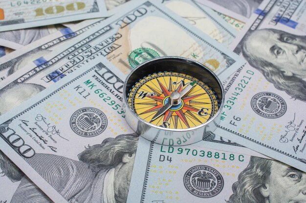 Zdjęcie kompas na tle banknotów dolara amerykańskiego inwestycja kryzys finansowy