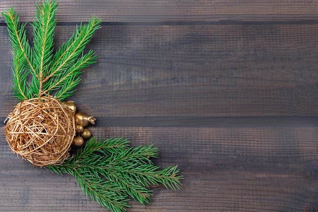 Kompozycja świąteczna. Rama gałęzi jodłowych i kulki na ciemnym rustykalnym drewnie