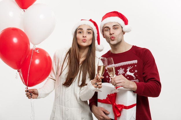 Koncepcja Bożego Narodzenia - Młoda Dziewczyna Trzyma Balon I Szampana, Grając I świętując Ze Swoim Chłopakiem W Boże Narodzenie.