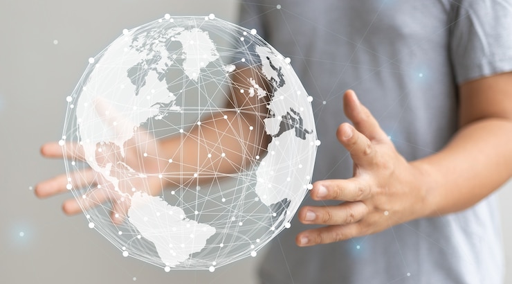 Zdjęcie koncepcja globalizacji z ręką trzymającą światową graficzną ilustrację