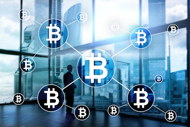 Koncepcja kryptowaluty Bitcoin i technologii blockchain na rozmytym tle drapaczy chmur