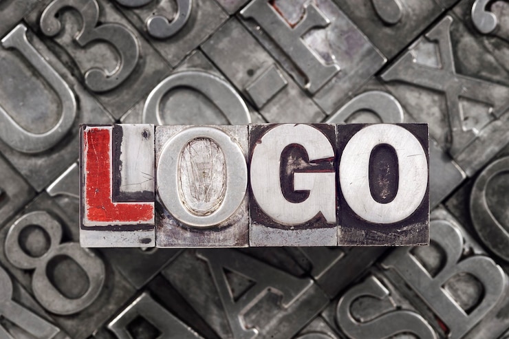 Zdjęcie koncepcja logo wykonana z metalowych bloków typograficznych na tle wielu liter