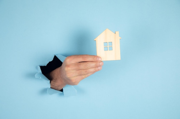Koncepcja nieruchomości Mężczyzna trzyma model domu