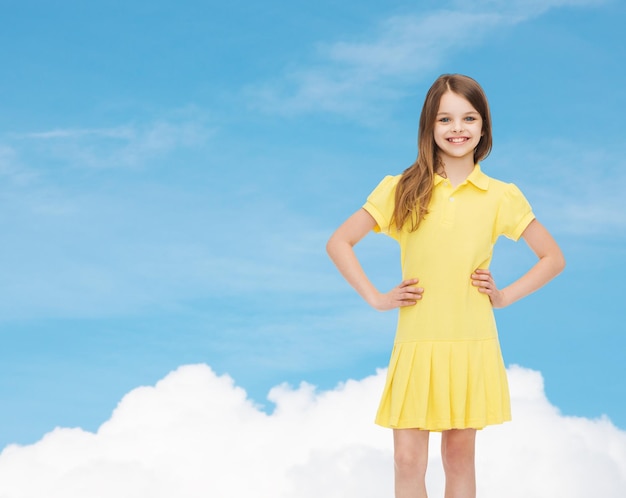 koncepcja szczęścia, dzieciństwa i ludzi - uśmiechnięta dziewczynka w żółtej sukience