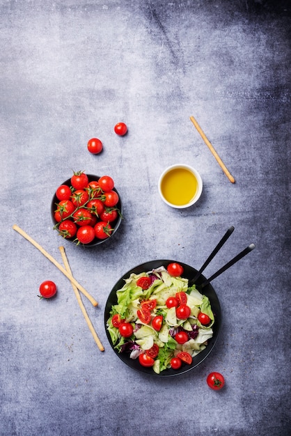 Koncepcja zdrowej żywności wegańskiej. Sałatka z ogórkiem, pomidorem, zieloną sałatą i cykorią