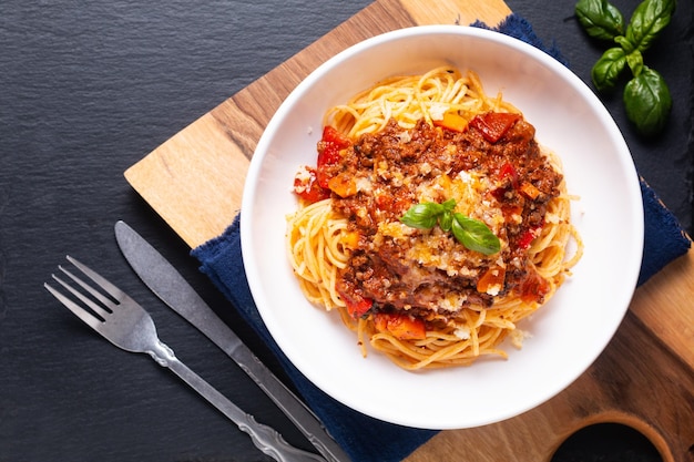 Koncepcja żywności Domowej Roboty Organiczne Spaghetti Bolognese W Misce Makaronu Na Drewnianej Desce Z Czarnym Tłem I Miejscem Na Kopię