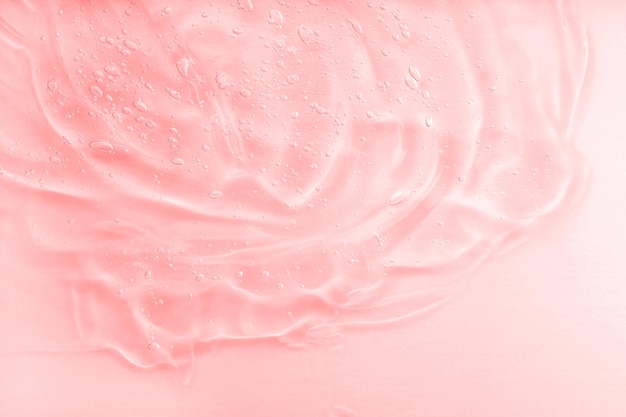 Konsystencja serum z galaretką kosmetyczną Przezroczysty żel nawilżający z kolagenem tło Różowa płynna przezroczysta próbka produktu do pielęgnacji skóry Emulsja
