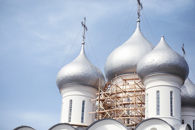 Kopuły budynku sakralnego. Krzyże na kopułach kościoła. Katedra ze srebrnymi kopułami na tle nieba