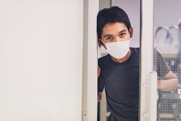 Zdjęcie koronawirus lub covid-19. azjatyccy mężczyźni w maskach ochronnych, pracują w domu z żelem dezynfekującym.