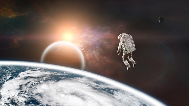 Kosmonauta unoszący się blisko Ziemi w przestrzeni kosmicznej z obcymi planetami