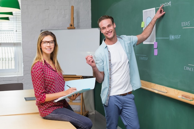 Kreatywnie ludzie biznesu przy pracą przeciw blackboard