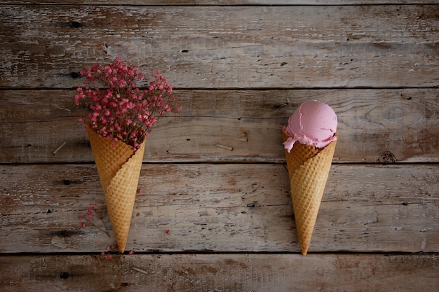 Kremowe Lody Malinowe Z Jagodami Malinowymi I Różowe Kwiaty W Rożku Waflowym Na Starym Drewnianym Stole