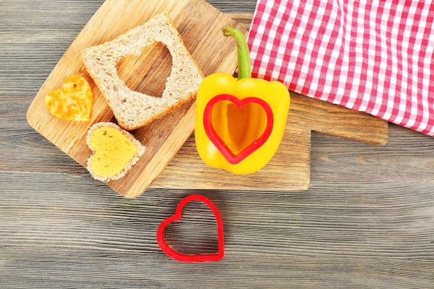 Kromka chleba z wycięciem w kształcie serca i pieprzem na stole z bliska