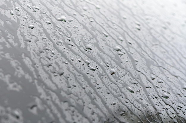 Krople wody w deszczowe dni na lustro boczne okna samochodu