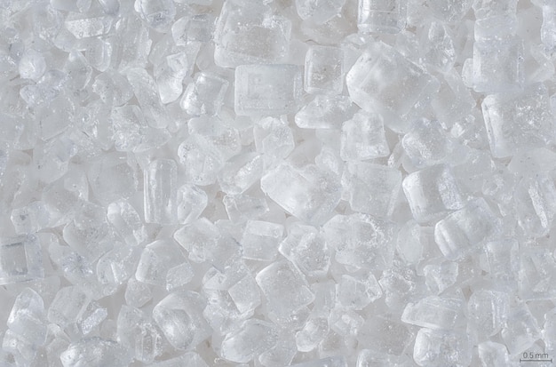 Kryształy cukru pod mikroskopem, powiększenie 4x - abstrakcyjne tło nauki