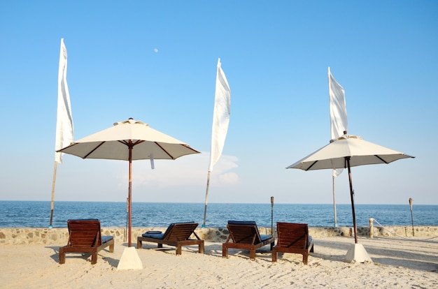 Krzesła na białej piaszczystej plaży