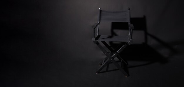 Krzesło reżysera czarny na białym tle na czarnym tle
