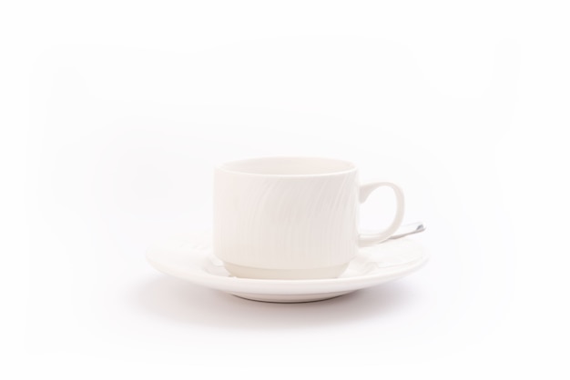 Zdjęcie kubek do kawy na białym tle na białym tle i łyżka