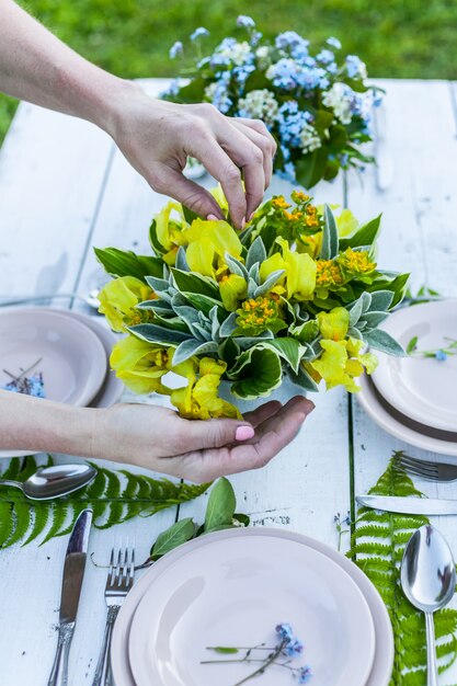 Kwiaciarnia co elegancki bukiet żółte Irysy na biały drewniany stół.