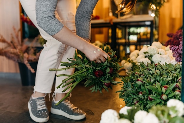 Kwiaciarnia kobieta robi bukiet w kwiaciarni
