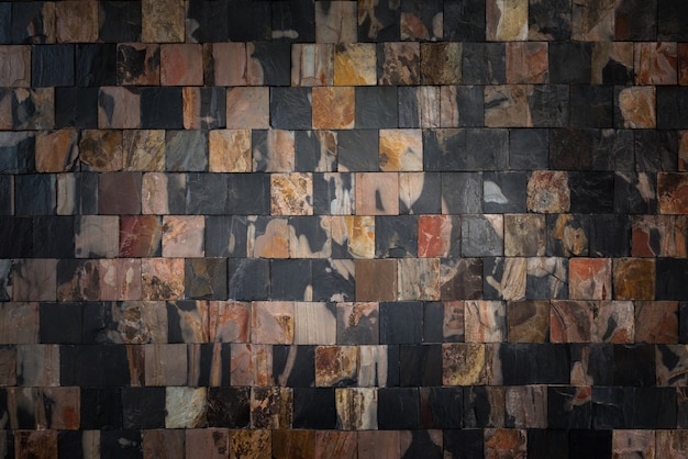 Łamigłówki kamiennej ściany tło i tekstura, Otaczająca czarna kamienna ściana dla tła