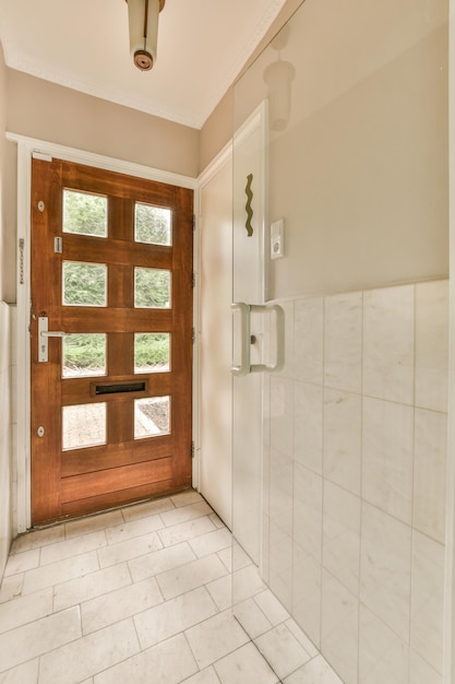 Łazienka z drewnianymi drzwiami i białymi płytkami na podłodze przed kabiną prysznicową jest otwarta na zewnątrz